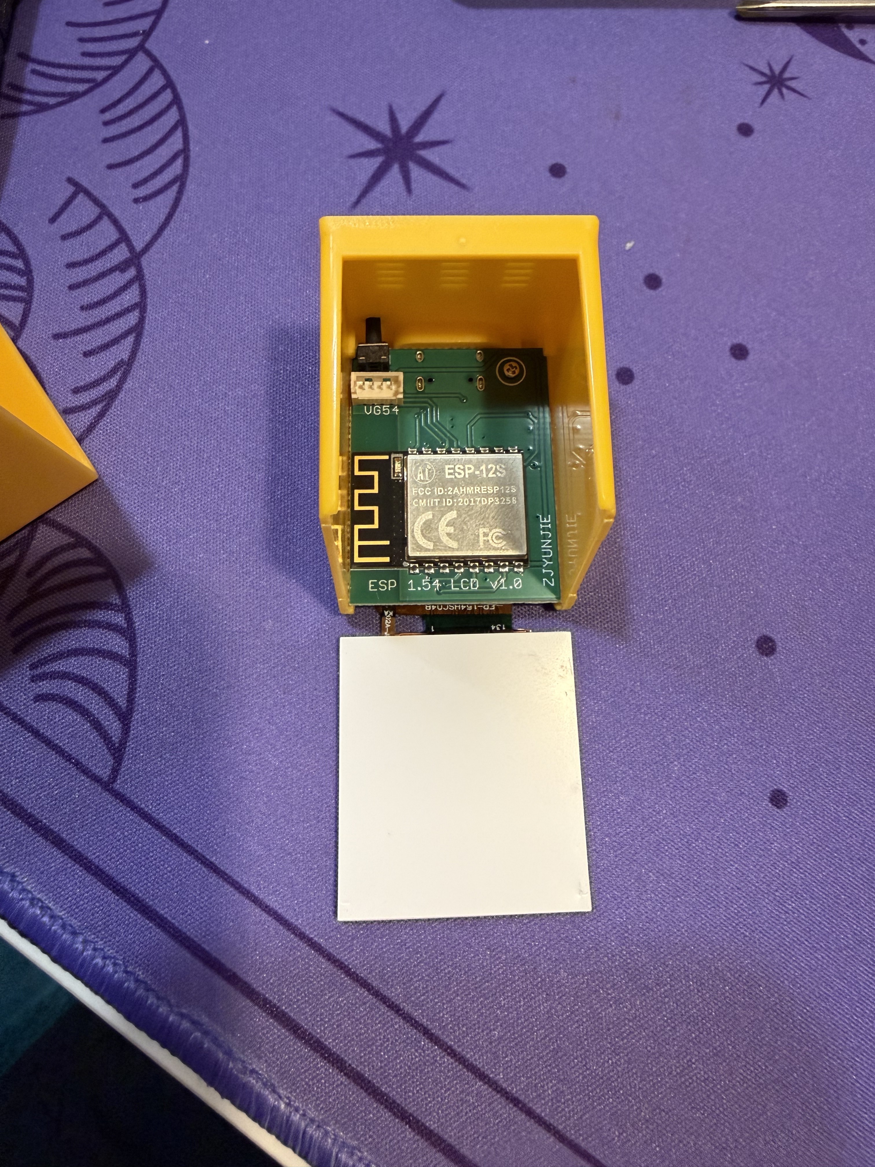 The main PCB slid out of the case, revealing an ESP-12S WiFi module and the board labeled "ESP 1.54 LCD V1.0" by ZJYUNJIE