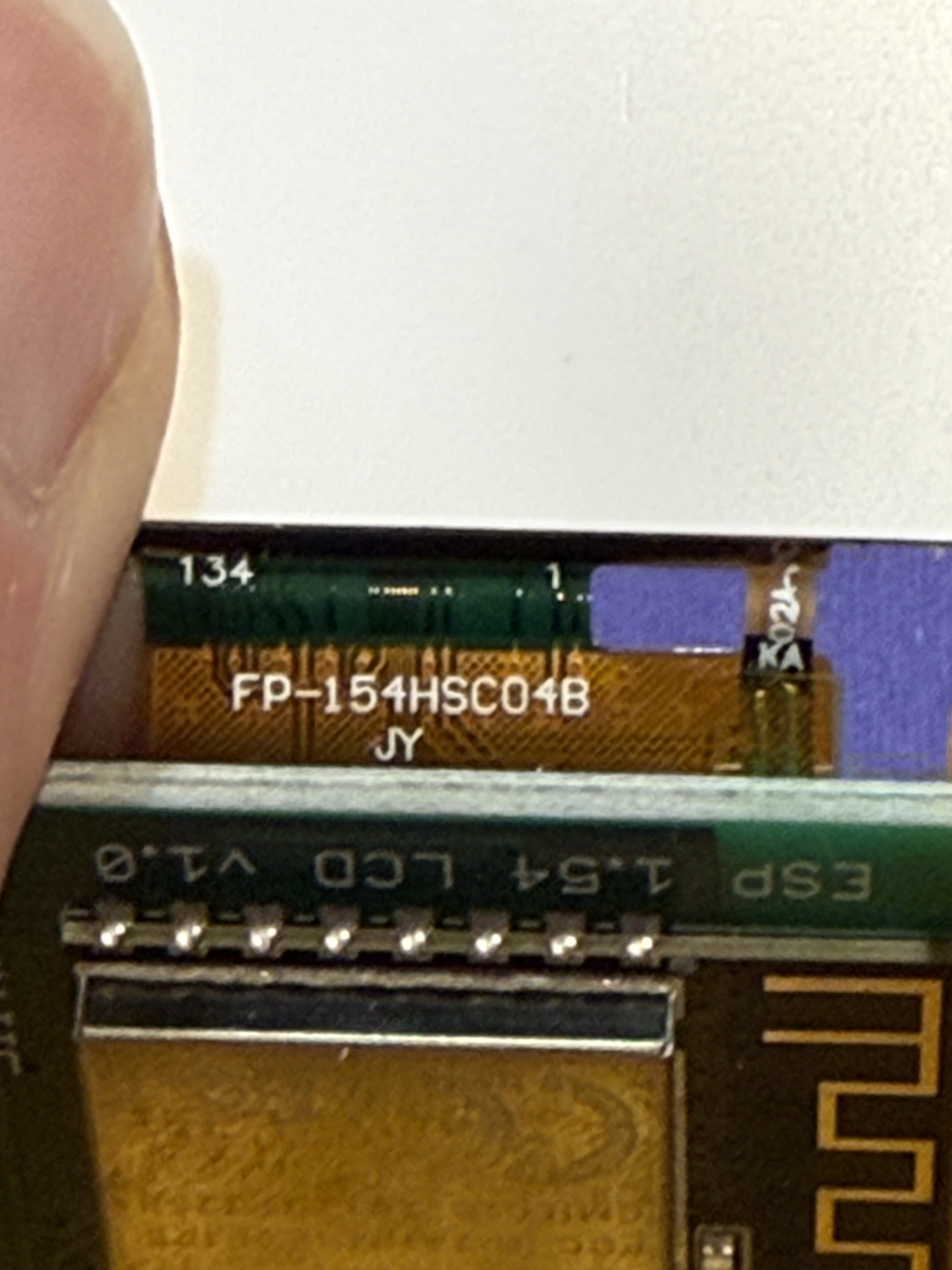 Close-up of the ribbon cable showing the part number FP-154HSC04B and the PCB edge labeled ESP 1.54 LCD V1.0